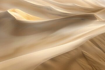 Aerial view of vast desert dunes, showcasing the flowing lines and soft curves of the sand formations. Capture the interplay of light and shadow, creating a sense of depth and texture. 