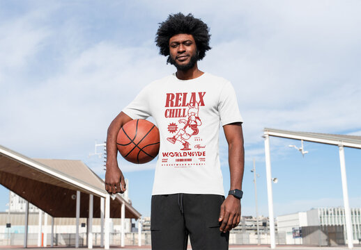 Mockup of man wearing customized t-shirt holding basketball