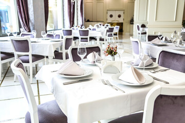 Spacious Dining Room With Multiple Tables and Chairs