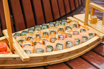 Wooden Boat Filled With an Array of Sushi Rolls