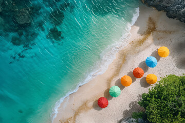 Fototapeta premium An aerial view of a tropical beach with clear turquoise water, white sand, and a row of colorful umbrellas.