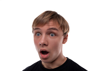 Fototapeta premium Headshot portrait of a blond Caucasian guy with blond hair, surprised with his mouth wide open