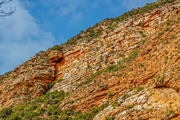 Towering cliff made of red sedimentary rocks in the Rooiberg Mountains in the Little Karoo, Western...