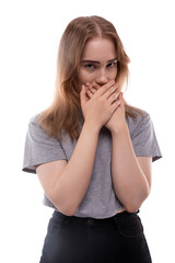 Fearful teenage girl with blond hair in a T-shirt on a white background
