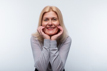 Happy 45 year old woman with blond hair looks carefree