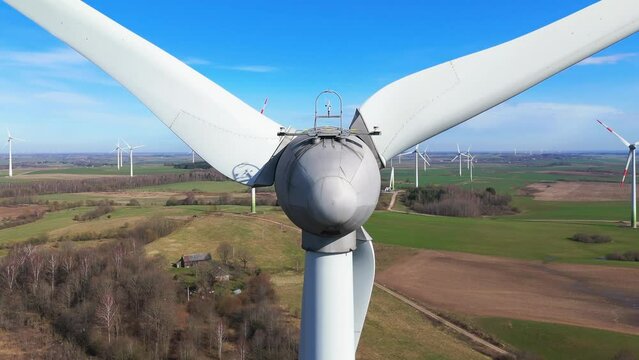 Close-up shot of energy producing wind turbine in a vast field on a sunny day in Taurage, Lithuania