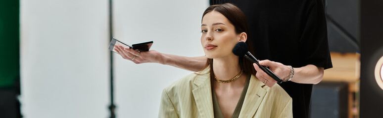 Makeup artist using brush applying product on womans face.