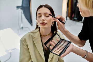 Professional makeup artist applying makeup to a woman.