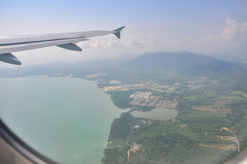 View of the wing from an airplane flying over Thailand