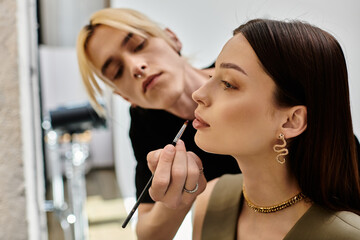 A woman receives a professional makeup application from another woman.