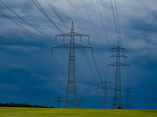 Strommasten und dunkle Regenwolken