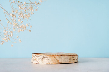 Wooden pedestal, podium with dry white and brown leaves