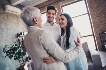 Portrait of group friendly corporate coworkers embrace communicate loft interior modern office indoors