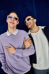 Two men in sunglasses striking a pose together.