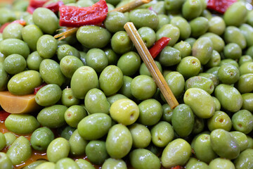 Marinated green olives background. Spanish appetizer
