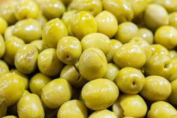 Split green olives background. Spanish appetizer