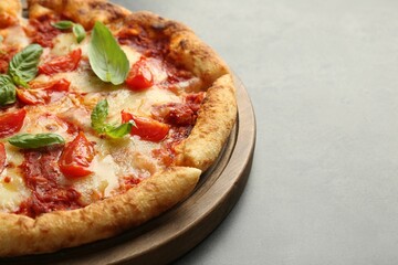 Delicious Margherita pizza on grey table, closeup. Space for text