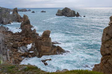 The naturalistic style captures the wild beauty of the coastal landscape, suitable for themes of travel, nature conservation, or outdoor adventure.