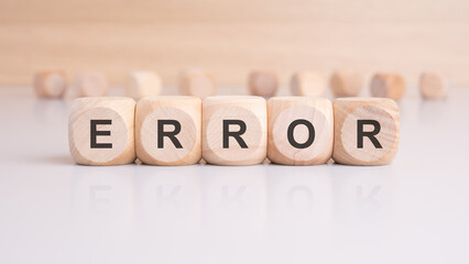 wooden cubes with letters form the expression ERROR. finance and business concept