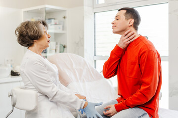 Fototapeta premium Attractive, young patient, man talking to senior woman, cosmetologist, about face aesthetic treatment
