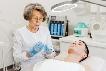 Professional, attractive, smiling senior woman, cosmetologist doctor working in modern office