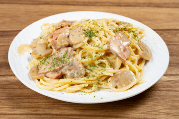 angle view spaghetti with creamed mushroom and bacon sauce at horizontal composition