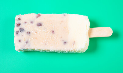 top view milkshake flavor popsicle with red beans on green background