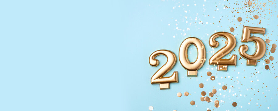 Golden 2025 on a blue color background with confetti and bokeh lights. Happy New Year 2025 is coming concept. Top view.