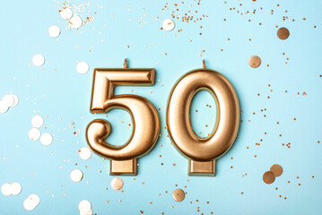 50 years celebration. Greeting banner. Gold candles in the form of number forty on blue background...