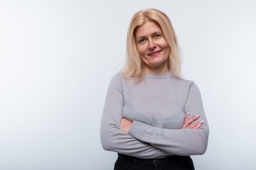 European woman with blond hair is confident in herself on a white background