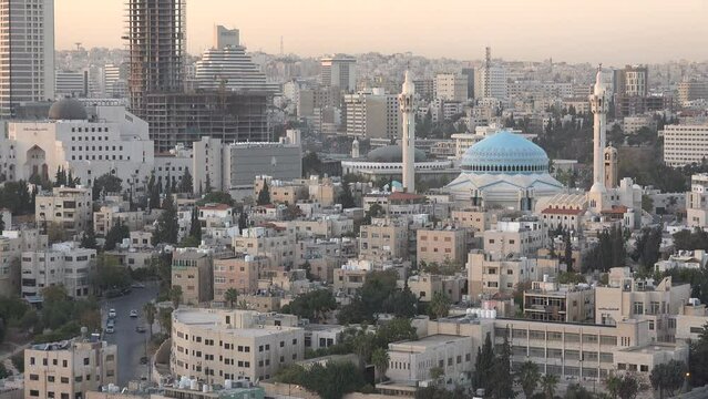 Contrast between modern office towers and the King Abdullah mosque in Amman, religion in the Middle East
