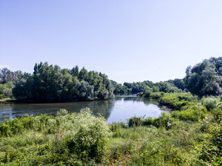 View to land, river, trees and empty blue sky