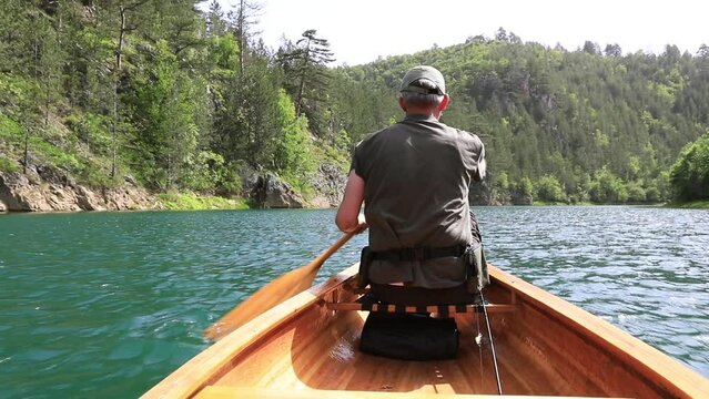 Man paddling canoe on the lake