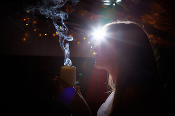 Middle aged beautiful woman holds aromatic candle in hands. Aromatherapy, meditation, healthy life...