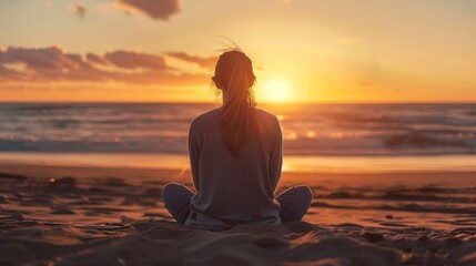 a woman sitting on the sand in the beach looking to the horizon at sunset