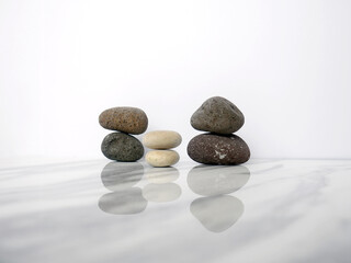 Zen basalt stone on white marble background