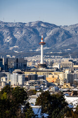 Obraz premium View of Nidec Kyoto Tower with the city skyline and mountains in the background. Kyoto, Japan