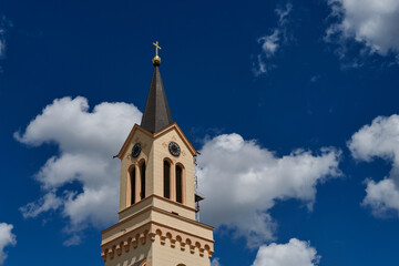 Zrenjanin downtown, city architecture, urban landscape. The clock tower on top of the Catholic...