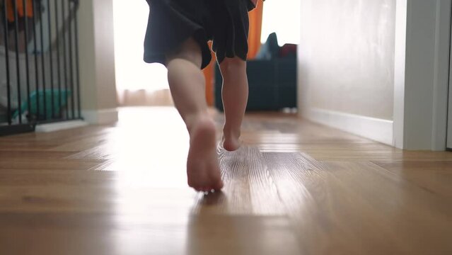 baby son run along the corridor indoors. happy family kid dream concept. baby son run playing holding a toy excavator. baby run to the window indoors smiling and lifestyle laughing