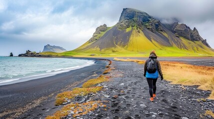 Solitary Traveler Hiking on Black Sand Beach in Iceland