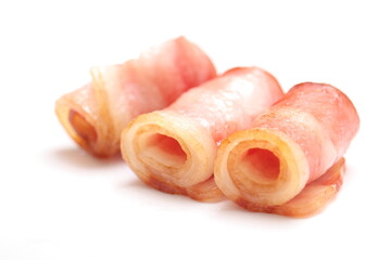 Close up of fried bacon pieces isolated white background.