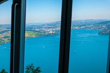 Fototapeta premium Window View From Cable Car on Mountain Side and Lake Lucerne in a Sunny Day in Burgenstock, Nidwalden in Switzerland.