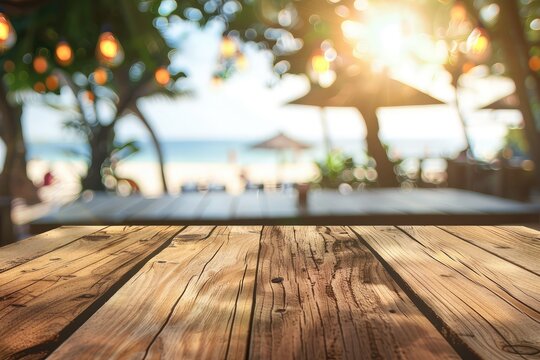 Empty wooden table top with copy space for food drink product advertising with blurred summer resort beach bar restaurant background