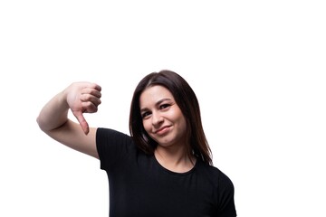 Young pretty European woman dressed in a black T-shirt shows dislike