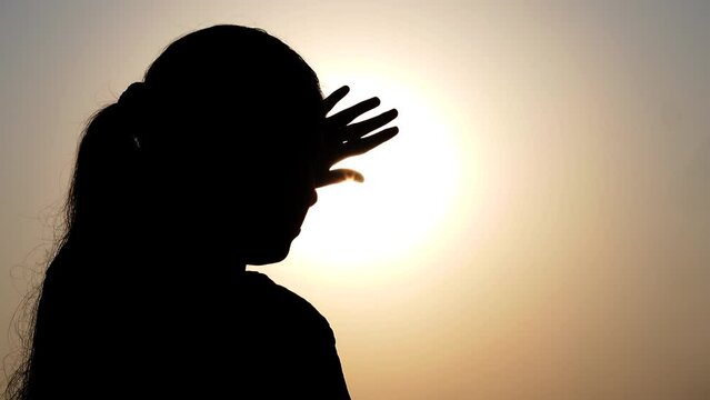 A woman wears sunglasses to protect herself from the harsh sun. 