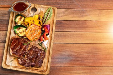 Traditional barbecue meat with vegetables and sauce