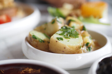 fork pick boiled potatoes on breakfast table 