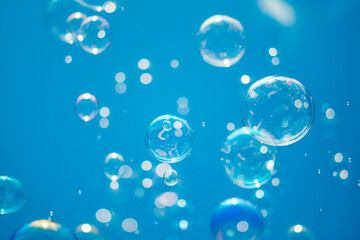 soap bubbles fly on a blue background