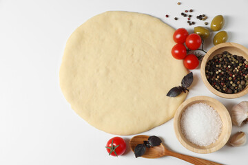 Fresh pizza dough and products on white background, flat lay. Space for text