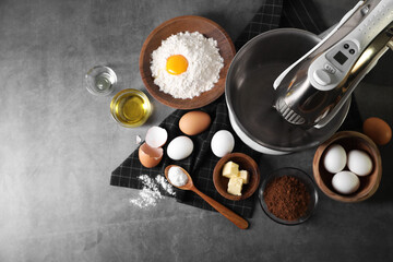 Stand mixer and different ingredients for dough on grey table, flat lay. Space for text
